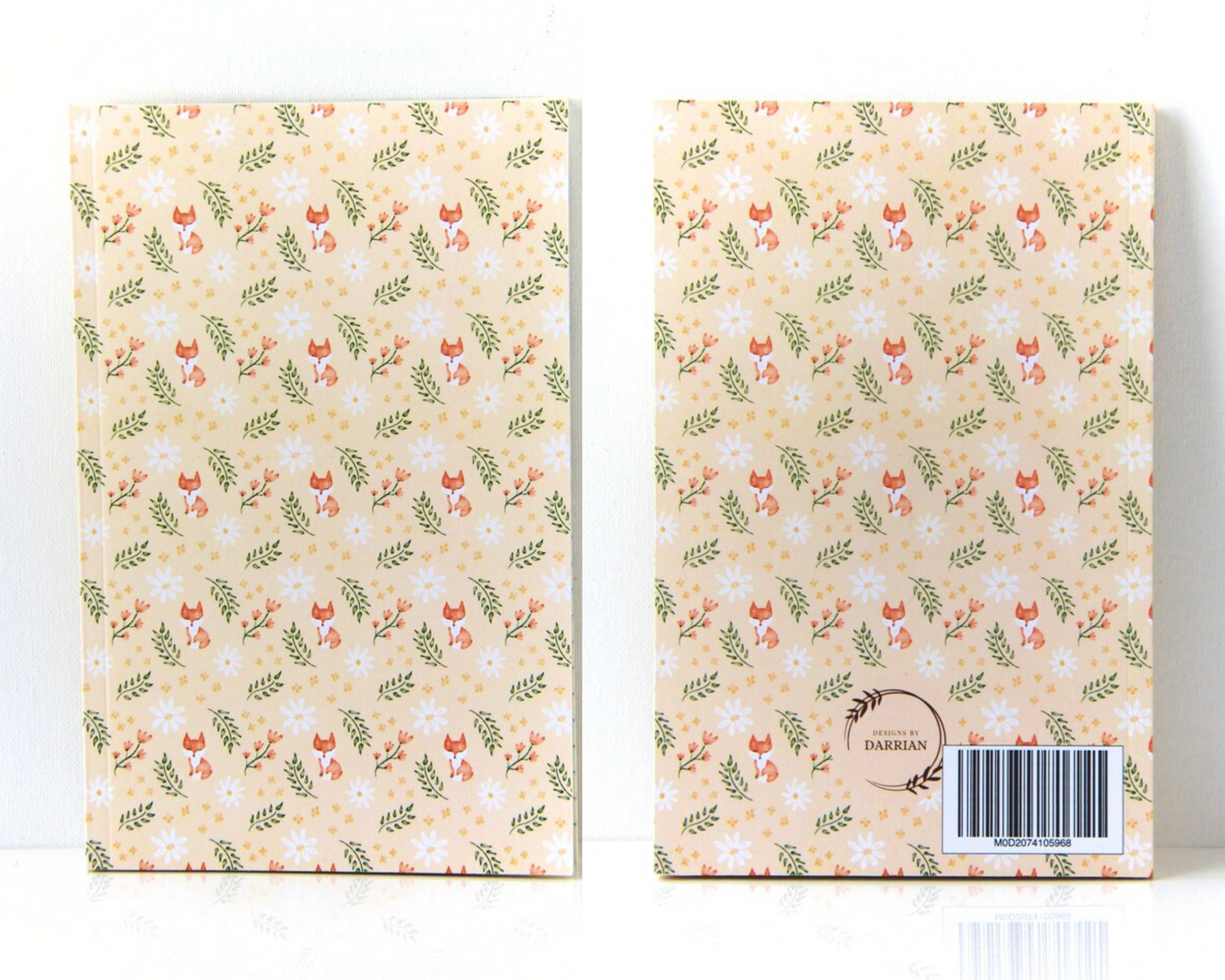 Notebook front and back with cream covers featuring a watercolour pattern with orange foxes, daisies, orange and yellow flowers, and leaves.