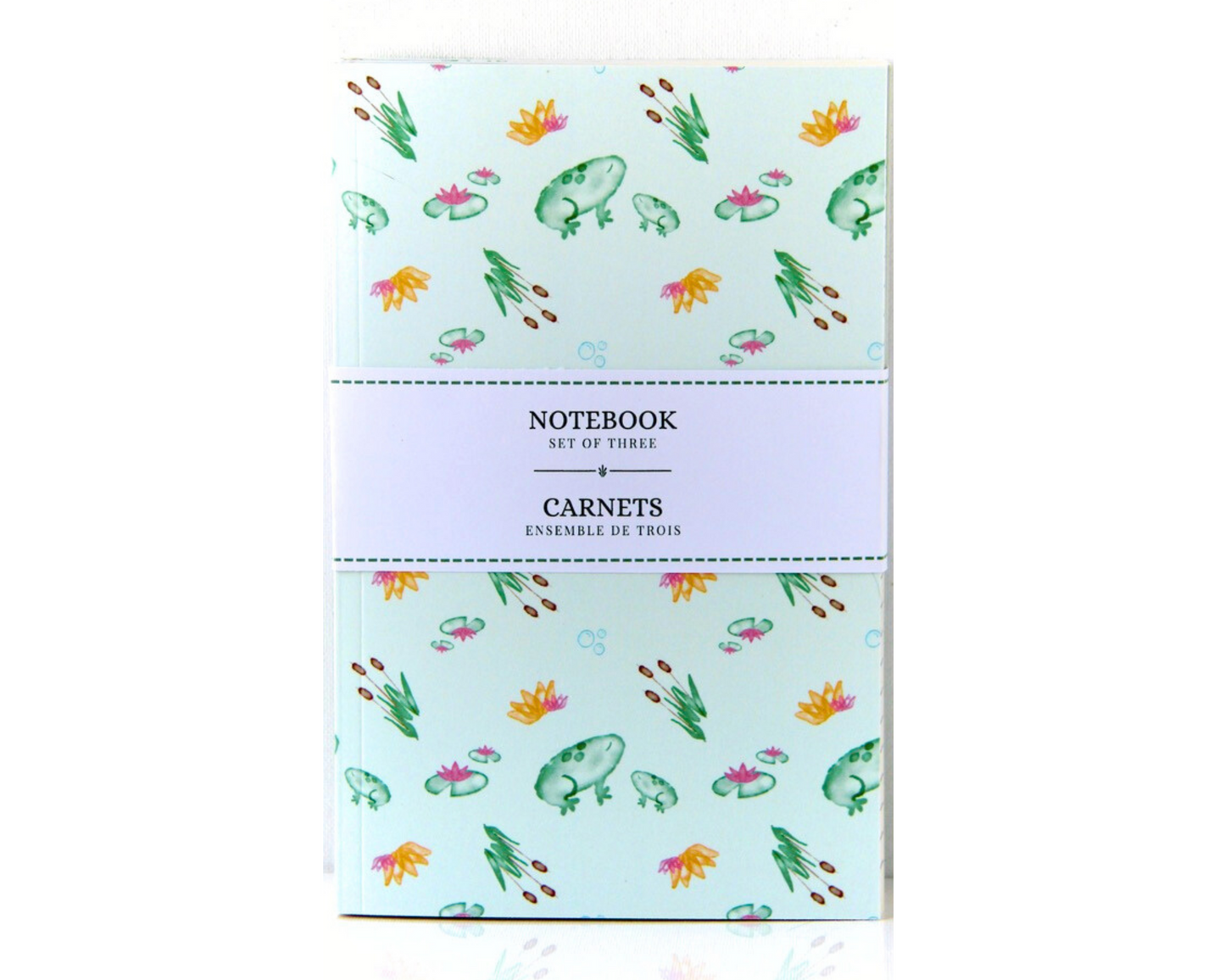 Pastel Green Notebook Set of Three with covers featuring green watercolour frogs, cattails, lily pads, and orange and pink lotus flowers