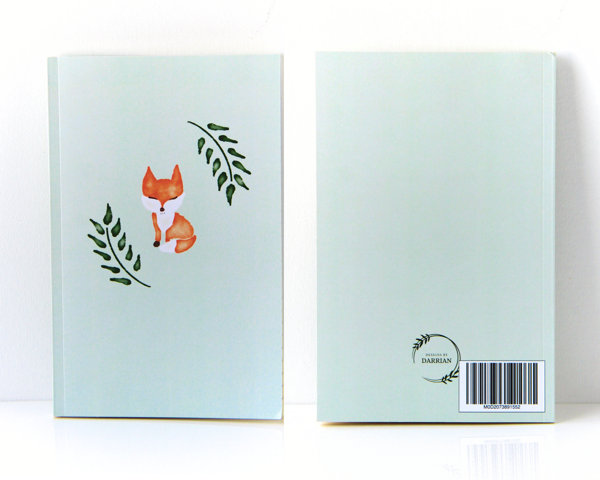 Front and Back of a sage green notebook featuring an orange watercolour fox and green leaves in the centre of the cover.